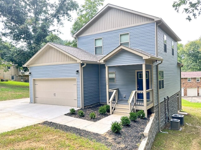 traditional home featuring roof with shingles, central air condition unit, a porch, concrete driveway, and an attached garage