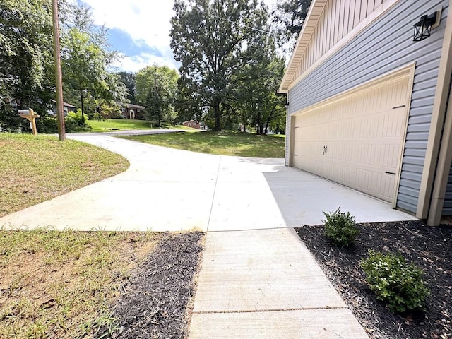 garage with concrete driveway