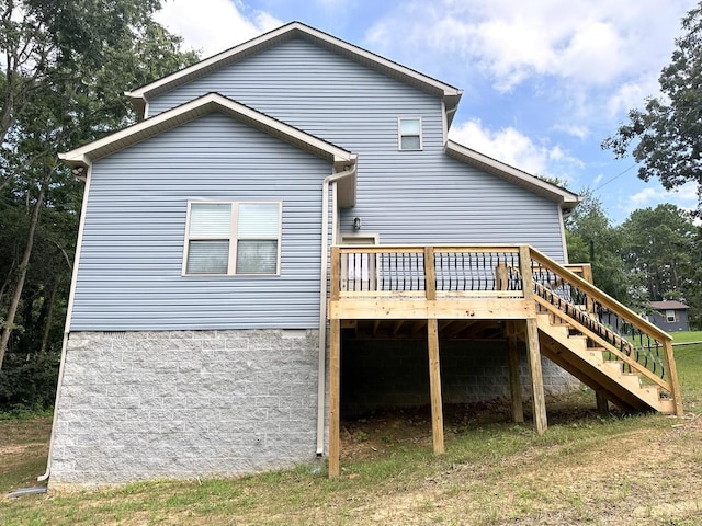 back of property with stairs and a deck