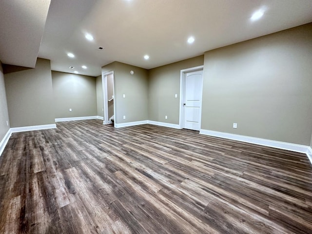 finished below grade area with recessed lighting, dark wood-style flooring, and baseboards