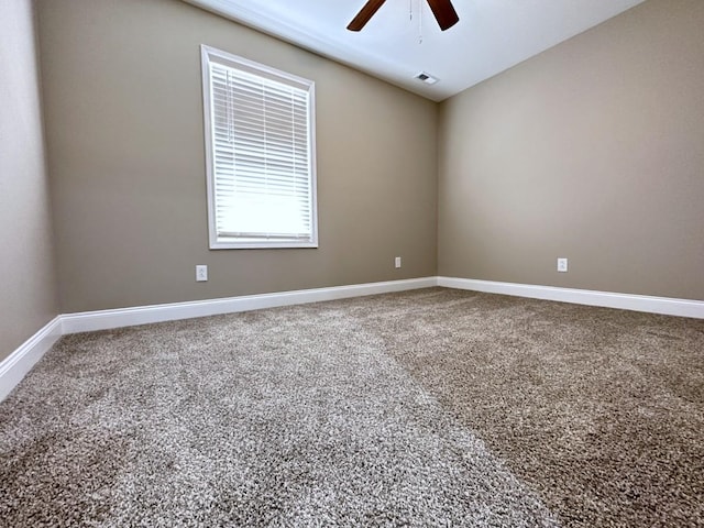 unfurnished room with ceiling fan, carpet floors, lofted ceiling, and baseboards