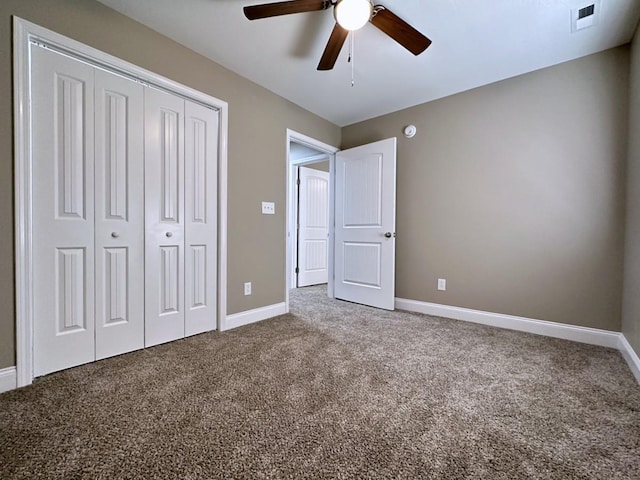 unfurnished bedroom with baseboards, a closet, visible vents, and carpet flooring