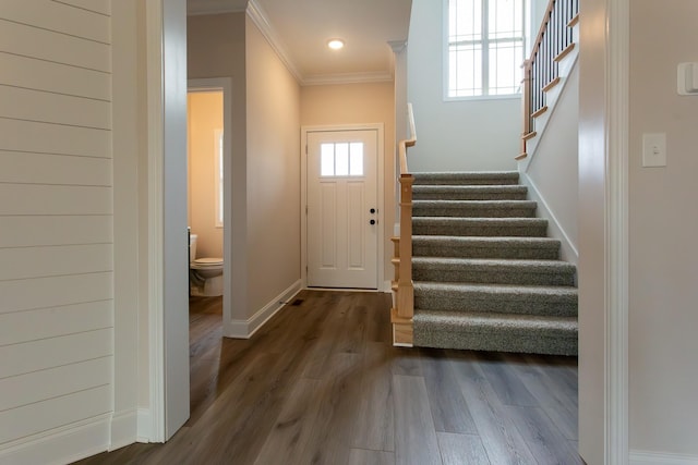 foyer entrance with baseboards, wood finished floors, stairs, crown molding, and recessed lighting