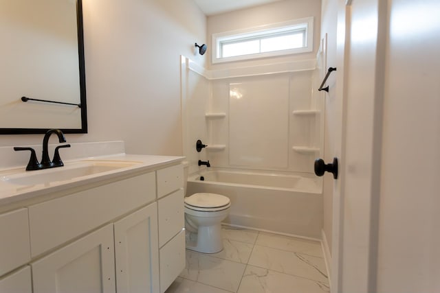 bathroom featuring marble finish floor, vanity, toilet, and bathtub / shower combination