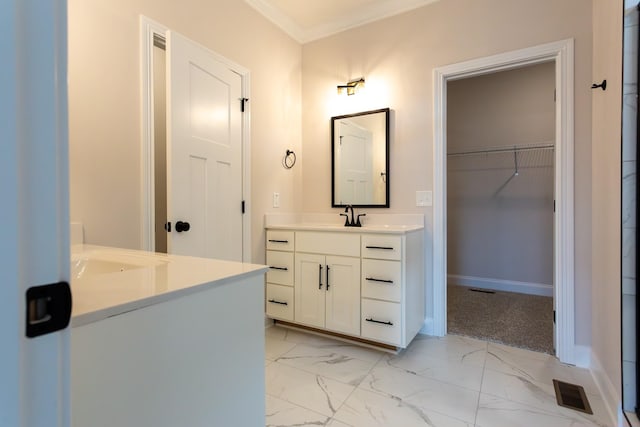 full bathroom featuring a walk in closet, marble finish floor, crown molding, visible vents, and vanity