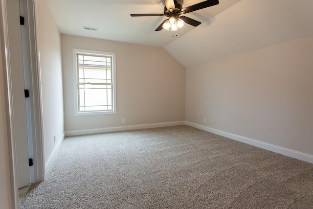 bonus room featuring light colored carpet, visible vents, a ceiling fan, vaulted ceiling, and baseboards