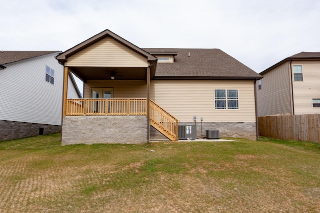 rear view of property with ceiling fan, central AC, fence, a yard, and crawl space