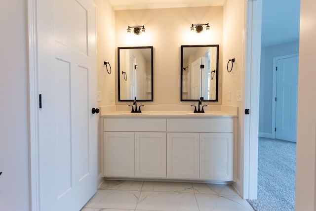 full bathroom with double vanity, marble finish floor, and a sink