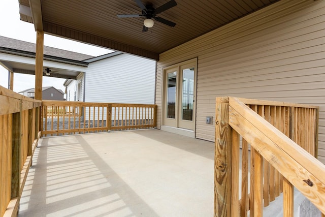 wooden terrace with ceiling fan and a patio