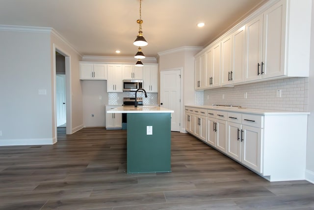 kitchen with white cabinetry and stainless steel microwave