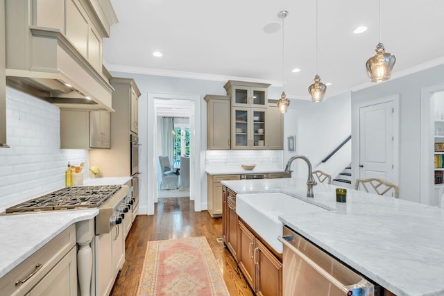 kitchen featuring stainless steel appliances, custom range hood, a sink, and crown molding