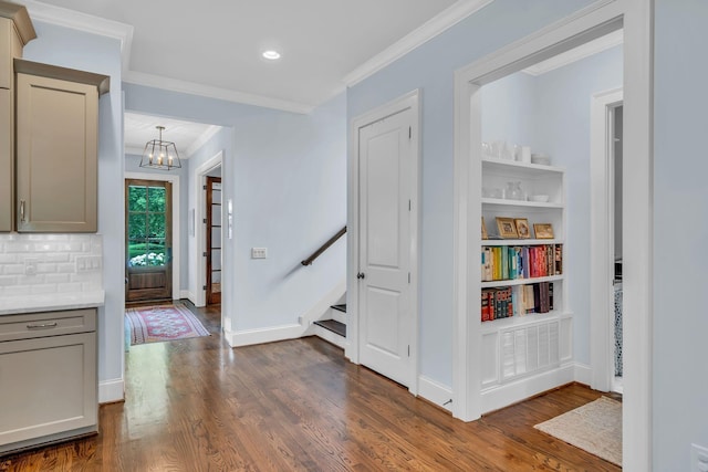 interior space with baseboards, ornamental molding, and dark wood finished floors