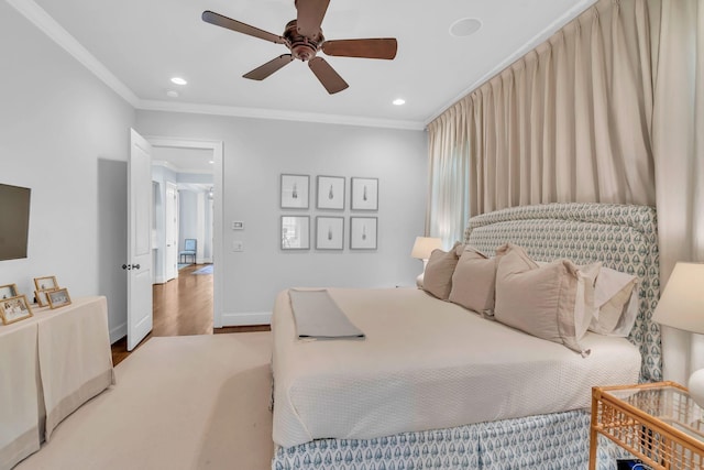 bedroom with recessed lighting, crown molding, baseboards, and wood finished floors