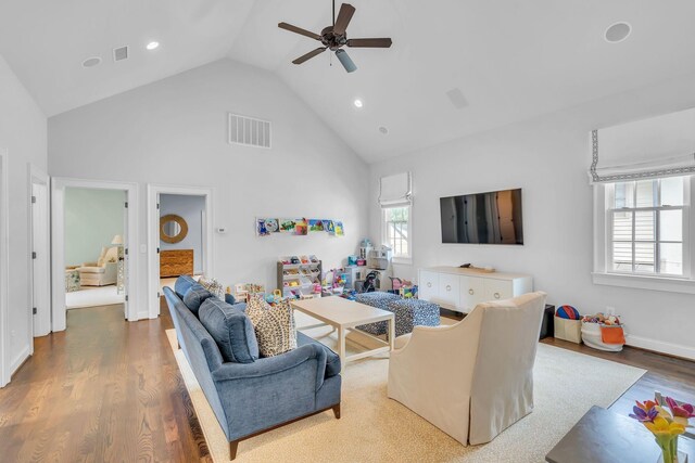 living area featuring ceiling fan, high vaulted ceiling, wood finished floors, and visible vents