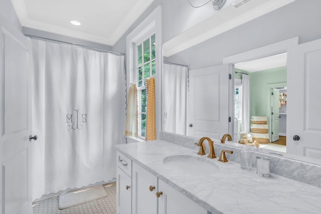 bathroom with ornamental molding, vanity, and tile patterned floors