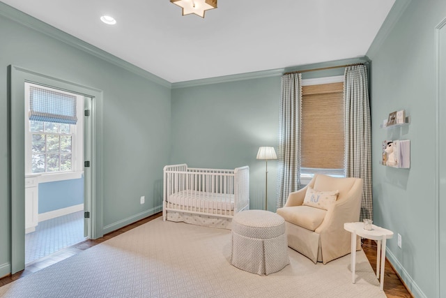 bedroom featuring baseboards, recessed lighting, wood finished floors, and crown molding