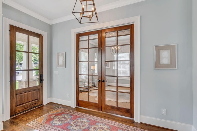 doorway with plenty of natural light, dark wood finished floors, a notable chandelier, and french doors