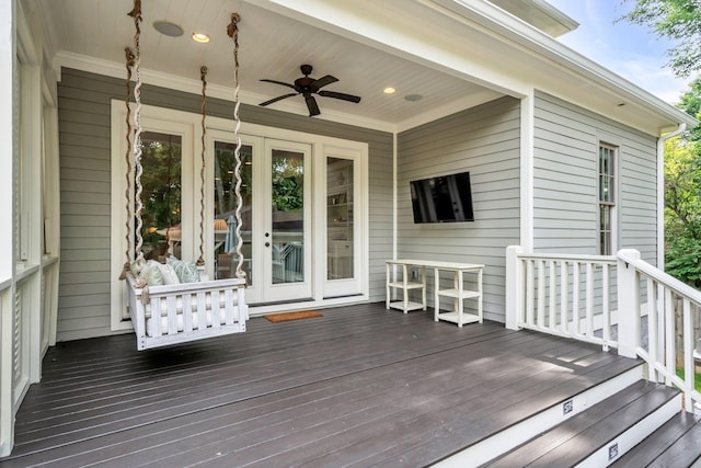 deck featuring a ceiling fan and french doors