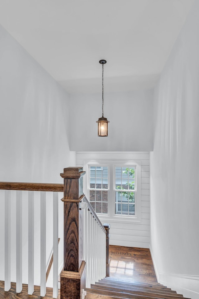 stairs with baseboards and wood finished floors