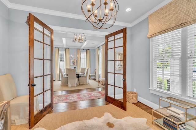 interior space with wood finished floors, baseboards, french doors, an inviting chandelier, and crown molding