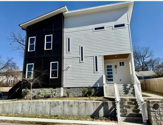 rear view of property featuring fence