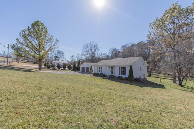 single story home with a garage and a front yard