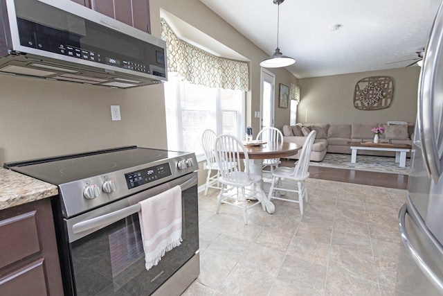 kitchen featuring ceiling fan, dark brown cabinetry, light countertops, appliances with stainless steel finishes, and decorative light fixtures