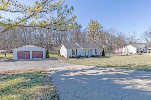 single story home with a detached garage, an outdoor structure, and a front yard