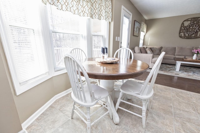 dining space with plenty of natural light and baseboards