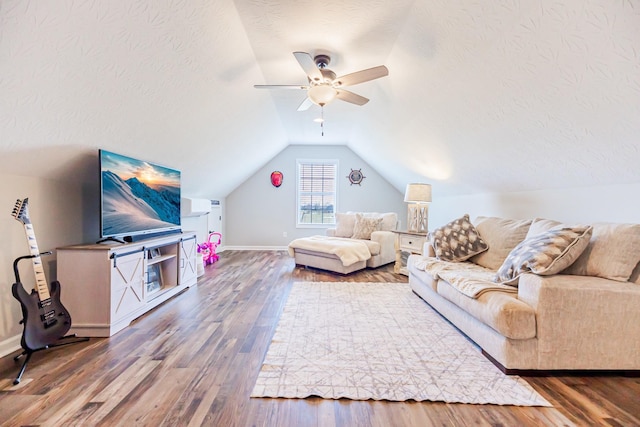 living area with lofted ceiling, ceiling fan, a textured ceiling, and wood finished floors