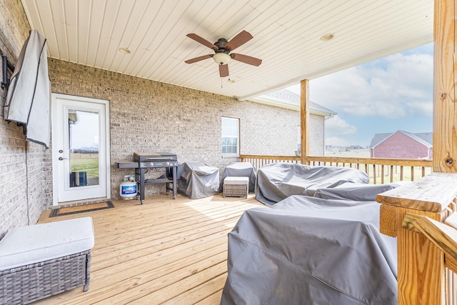 wooden deck featuring a ceiling fan and area for grilling