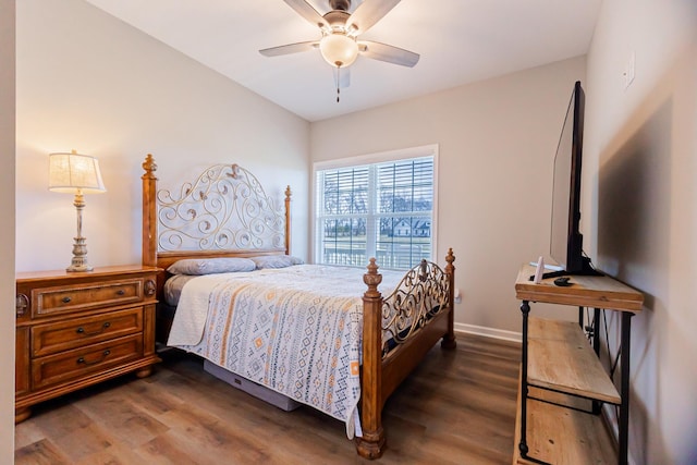 bedroom featuring dark wood-style floors, a ceiling fan, and baseboards