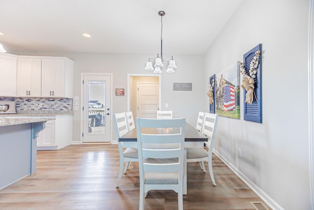 dining area with a chandelier, recessed lighting, visible vents, baseboards, and light wood finished floors