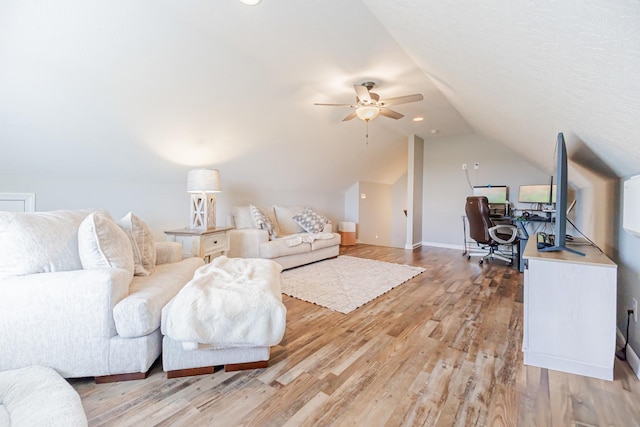 living room with light wood-style floors, baseboards, vaulted ceiling, and a ceiling fan