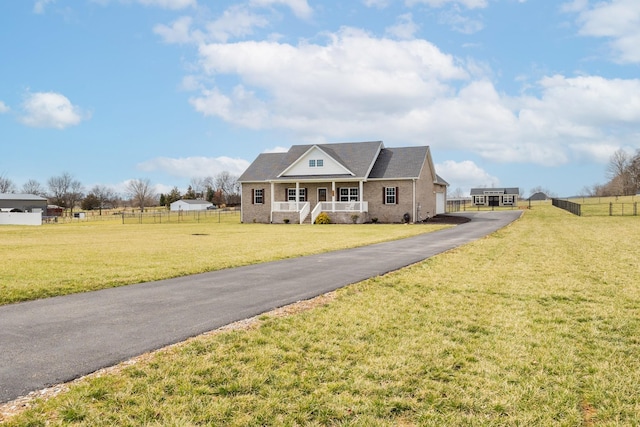 view of front of house with a porch, a front lawn, fence, and brick siding