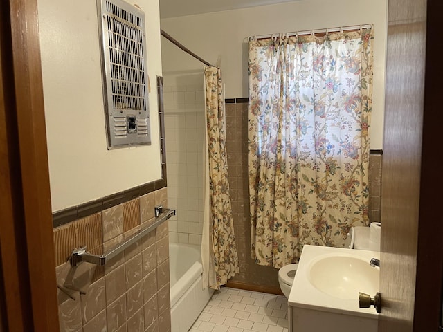 bathroom featuring tile patterned flooring, a wainscoted wall, shower / tub combo with curtain, and tile walls