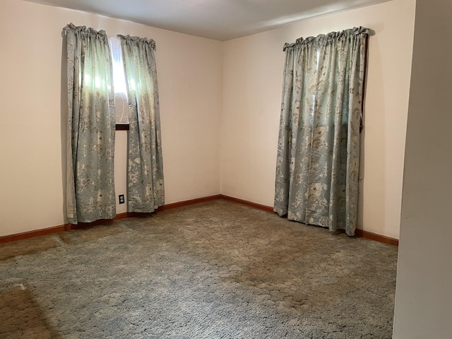 carpeted spare room with baseboards