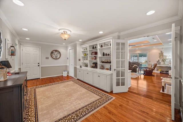 entrance foyer with light wood finished floors and ornamental molding