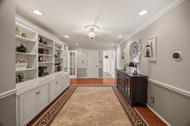 interior space with light wood-style floors, recessed lighting, and crown molding