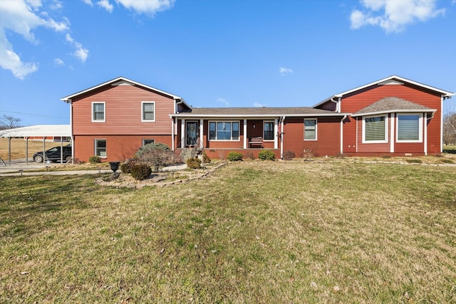 back of house with brick siding and a lawn