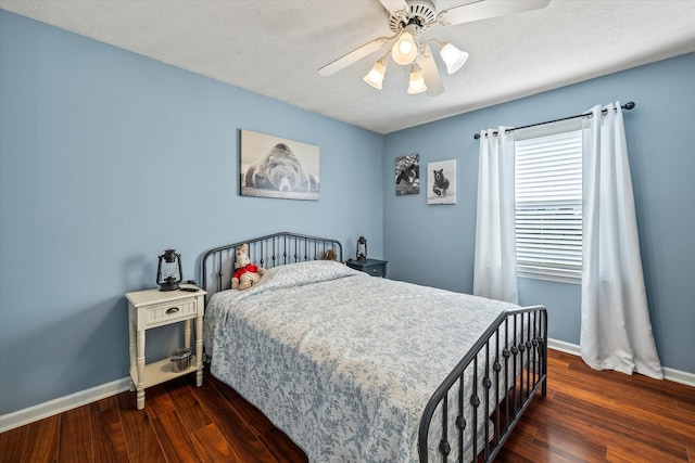 bedroom with ceiling fan, a textured ceiling, baseboards, and wood finished floors