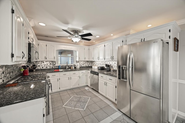 kitchen with light tile patterned floors, white cabinetry, appliances with stainless steel finishes, and a sink