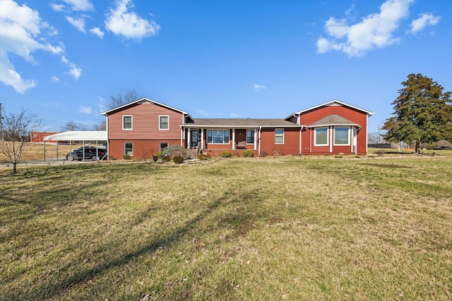 rear view of house featuring a lawn