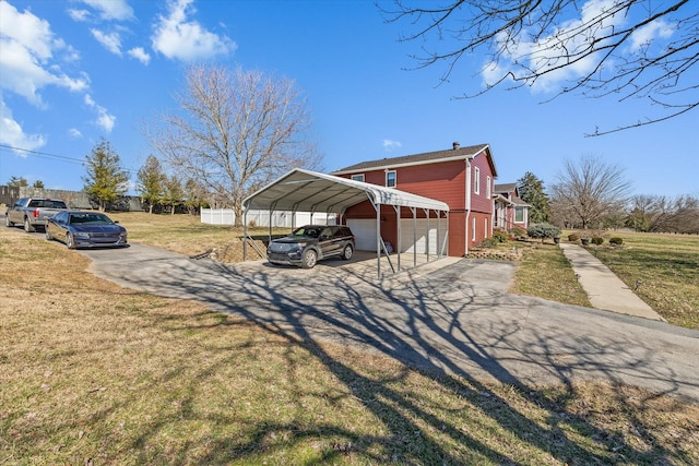 view of home's exterior with a garage, driveway, a yard, and fence