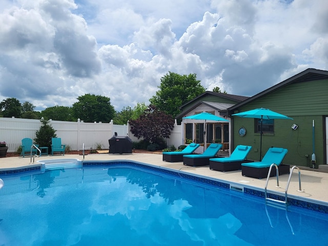 view of pool with a fenced in pool, fence, and a patio