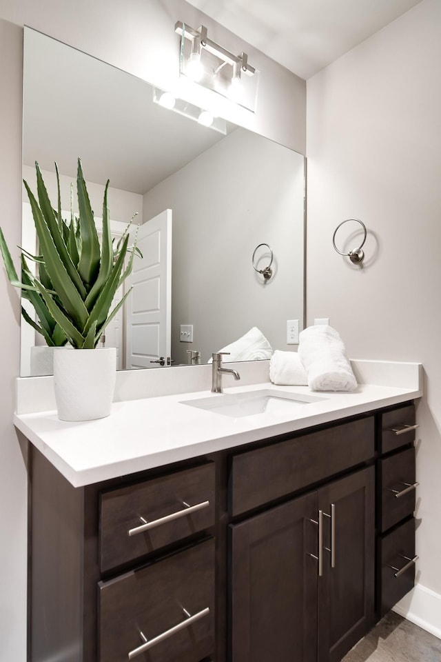 bathroom featuring baseboards and vanity