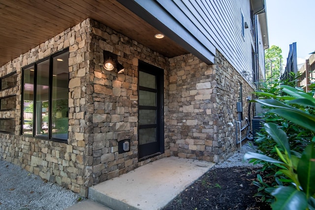 view of property exterior with stone siding