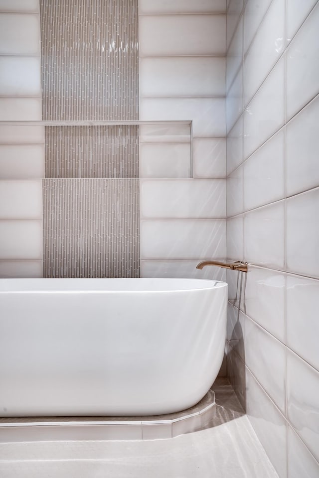 full bathroom featuring rustic walls and a freestanding tub