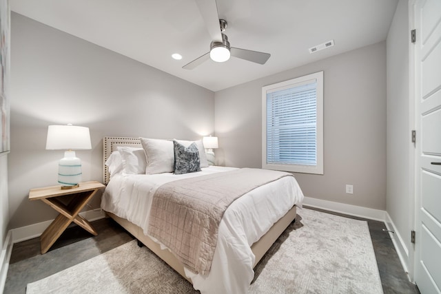 bedroom with a ceiling fan, concrete floors, visible vents, and baseboards