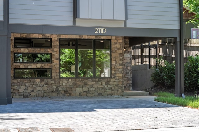 doorway to property featuring stone siding